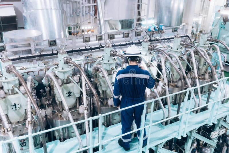 Marine engineer working inside a well-lit ship engine room